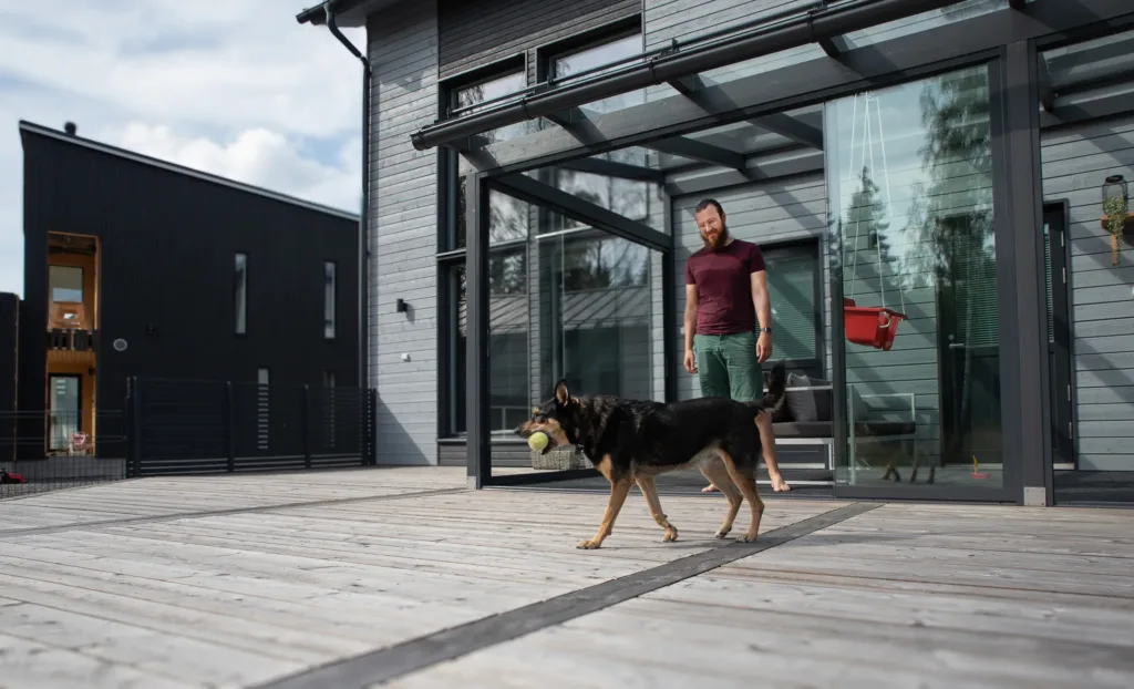 Mies ja koira Jamarin toteuttamalla terassilla